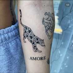 a person with a tattoo on their arm that has an image of a leopard and another animal