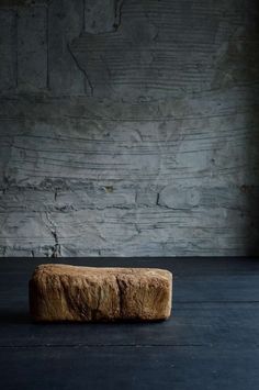 a piece of wood sitting on top of a black floor