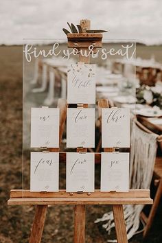 a wooden easer with place cards on it