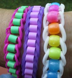 three different colored bracelets on someone's arm