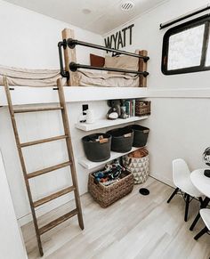 there is a bunk bed in the room with two baskets on the floor next to it