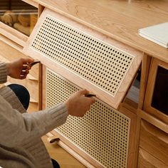 a woman is working on a piece of furniture with scissors and woodworking equipment in front of her