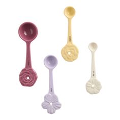 three spoons are shown in different colors and sizes, one is white, the other is pink