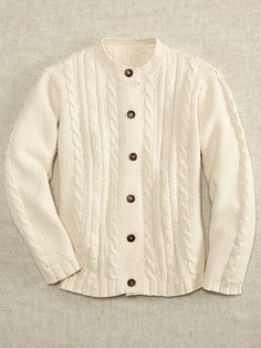 a white cardigan sweater with buttons on the front and back, sitting against a gray background