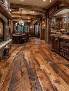 a large kitchen with wood floors and an open fireplace