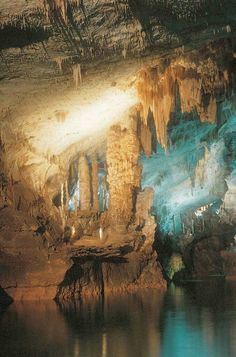 an image of the inside of a cave that is lit up with lights and water