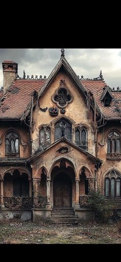 an old abandoned house with ivy growing on the roof and windows, in front of a cloudy sky