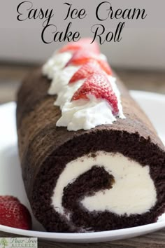 an easy ice cream cake roll on a plate with strawberries