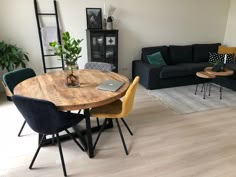 a living room filled with furniture and a wooden table in front of a black couch