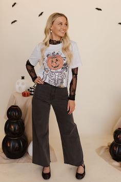 Get ready for a brew-tiful fall season with THE PUMPKIN COFFEE TEE IN ASH! This fun and quirky tee features a playful Jack-O-Lantern design and is perfect for coffee lovers. Super cute and full of fall vibes, it's the must-have addition to your wardrobe. Paired with THE SAYLOR WIDE LEG JEANS IN BLACK & THE LOLLI LACE BALLET FLAT IN BLACK Jack-O-Lantern coffee design Printed on Bella Canvas Tee Round neck Short sleeves 99% cotton, 1% polyester Runs true to size. Small (0-4), Medium (6-8), Large ( Black Lace Undershirt Outfit, Fitted Lace Top T-shirt With Crew Neck, Black T-shirt With Floral Print For Fall, Oversized Skull Print T-shirt For Fall, Lace Shirt Outfit, Fall Oversized T-shirt With Skull Print, Lace Ballet Flats, Spooky Short-sleeve Fall Shirt, Summer Goddess