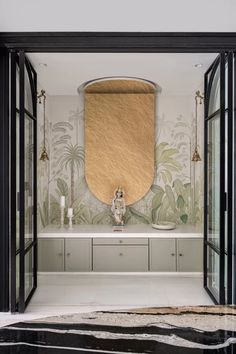 an open door leading to a bathroom with a mirror on the wall and cabinets below