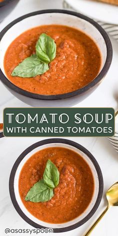 two bowls filled with tomato soup and basil leaves