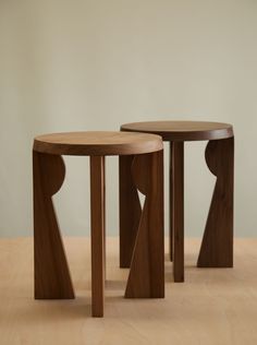 two wooden tables sitting on top of a hard wood floor