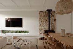 a living room filled with furniture and a flat screen tv mounted on the wall above a fireplace