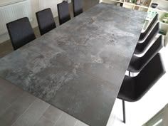 a large table with black chairs around it