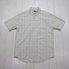 2000s/2010s Arnold Palmer Windowpane Seersucker Button Down Short Sleeve Shirt Size M/L condition - very good - tiny mark tagged M - fits oversized - please consult measurements  22" pit to pit  30.5" length    Please contact us if you have more questions about this garment. White Yarn-dyed Short Sleeve Shirt, Classic Plaid Cotton Short Sleeve Shirt, Classic Cotton Short Sleeve Plaid Shirt, Arnold Palmer, Button Down Short Sleeve, Button Down, Short Sleeve Shirt, Sleeve Shirt, Gender Neutral