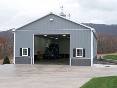 a large gray garage with a truck in it