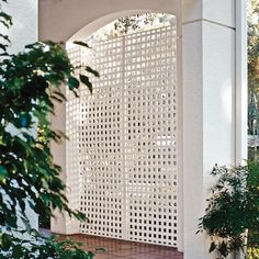 a white perfored wall on the outside of a house