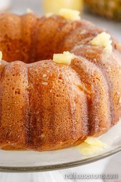 a bundt cake with pineapple topping on a glass plate