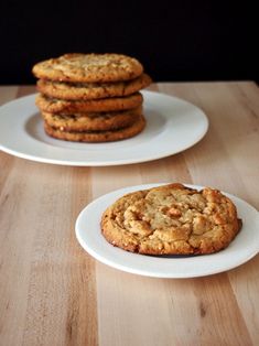 two white plates with cookies on them