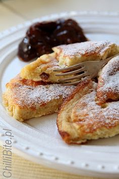 several pieces of bread with powdered sugar on them and an apple next to it