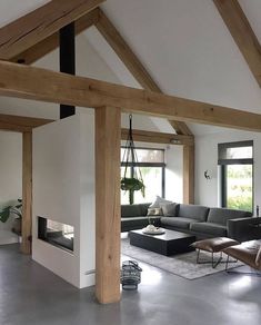 a living room filled with lots of furniture next to a fire place in a house