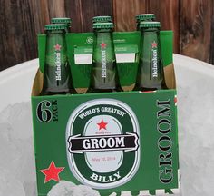 a group of six bottles of groom beer sitting on top of ice