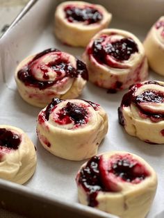 small pastries are sitting in a baking pan on the counter top, ready to be baked