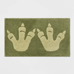 two hand prints on a green door mat