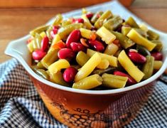 a close up of a bowl of food on a table with a cloth and napkin