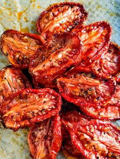 sliced up tomatoes sitting on top of a table