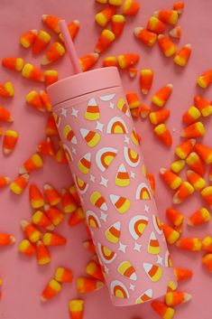 a pink cup with candy corn on it