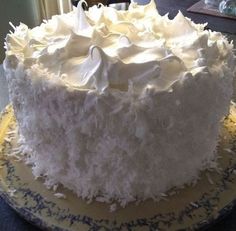 a white frosted cake sitting on top of a table