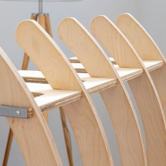 four wooden surfboards are lined up on a shelf with a lamp in the background