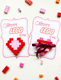 two lego valentine's day gift tags on a white background with pink and red bows