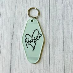 a keychain with the word nugg written on it and a heart in the middle