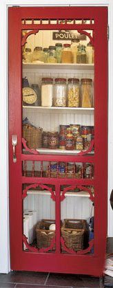 a red pantry door with spices and other items in it