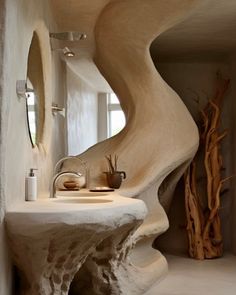 a bathroom with a sink, mirror and sculpture in it