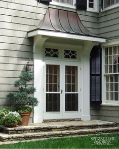 a white door and window in front of a house