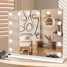 a mirror that has some lights on it in front of a table with makeup brushes