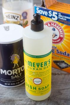 three different types of cleaning products sitting on a table next to each other, including soap and dish soap