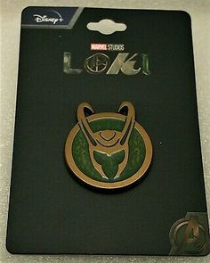 the avengers pin is sitting on top of a black card holder with a green and gold logo