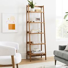 a living room filled with furniture and a tall wooden shelf next to a chair in front of a window