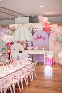 a room filled with lots of balloons and tables