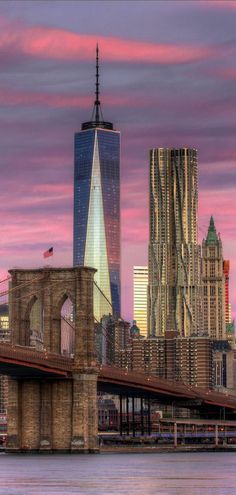 the skyline of new york city is shown at sunset