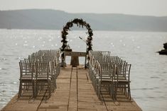 rows of chairs are set up on the dock for an outdoor ceremony