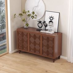 a wooden sideboard with two vases and a mirror on top