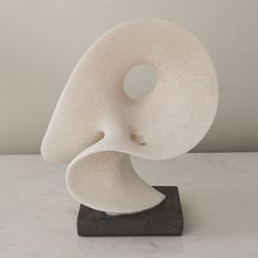 a white sculpture sitting on top of a table