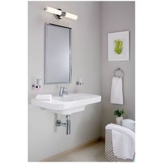 a bathroom with a sink, mirror and towel rack in the corner on the wall