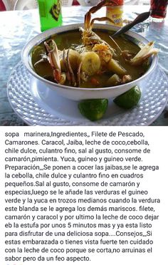 a bowl of food on top of a table with limes and other items in the background